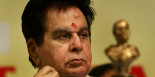 Veteran Bollywood actor Dilip Kumar looks on at a ceremony where he was awarded the Phalke Ratna for his services to the Indian film industry in Mumbai, India, Monday, April 30, 2007. The Phalke Ratna is presented by the Dadasaheb Phalke Academy, named after Dadasaheb Phalke, considered to be the founder of Indian cinema, is an all India body of 36 cine associations. In the foreground is a bust of Dadasaheb Phalke. (AP Photo/Gautam Singh)