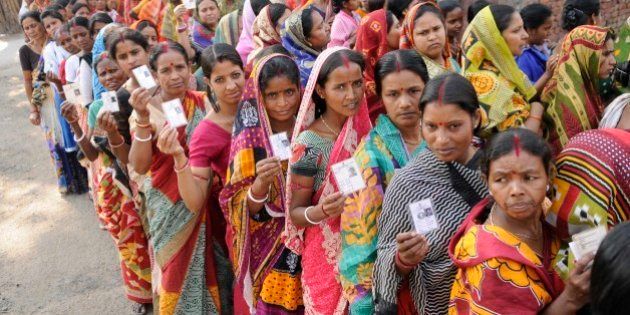 ASANSOL, INDIA - APRIL 11: People stand in a queue to cast their vote for West Bengal Assembly elections at Kendulia School, Jamuria on April 11, 2016 in Asansol, India. Amid sporadic incidents of clash and scorching heat, 79.56 per cent votes were cast on Monday in part two of the first phase of polling in 31 Assembly constituencies spread over three districts in West Bengal. (Photo by Samir Jana/Hindustan Times via Getty Images)