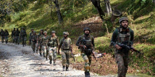Indian army soldiers take positions at Hafruda forest in Kashmir's Kupwara district, around 140 kilometres (85 miles) northwest of the main city of Srinagar, during a gunfight with militants on October 5, 2015. Suspected rebels killed four soldiers during firing overnight near the heavily militarised border dividing Kashmir between India and Pakistan, police said on October 5. AFP PHOTO (Photo credit should read STR/AFP/Getty Images)