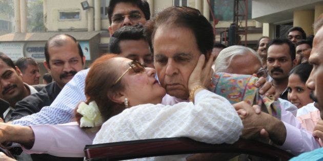 MUMBAI, INDIA - DECEMBER 11: Bollywood actor Dilip Kumar kissed by his wife, actress Saira Banu as he steps out of Lilavati Hospital to leave for his home on his 92nd birthday on December 11, 2014 in Mumbai, India. He was admitted last week for a chest infection. (Photo by Vijayanand Gupta/Hindustan Times via Getty Images)