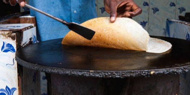 Dosa being made on the street at a food stall, Punducherry, Tamil Nadu.