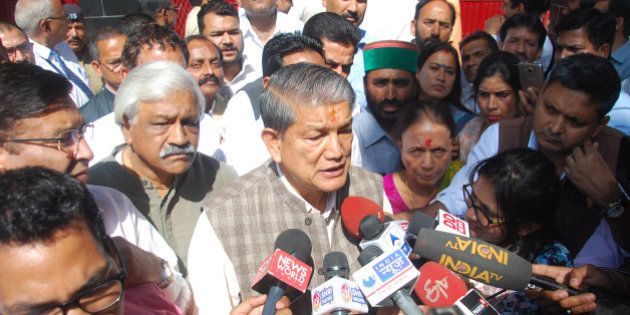 DEHRADUN, INDIA - MARCH 28: Former CM Harish Rawat with his MLAs and supporters coming out of the Governor's house on March 28, 2016 in Dehradun, India. Day after Presidentâs rule was imposed in Uttarakhand, Congress said it will approach all legal and constitutional forums against the injustice done to Harish Rawat government. (Photo by Vinay Santosh Kumar/Hindustan Times via Getty Images)