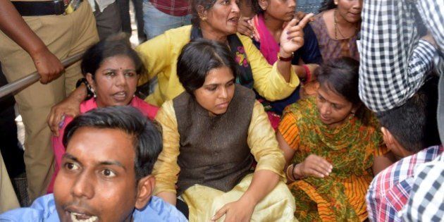Indian activists including Trupti Desai(C)gather as they attempt to enter The Shani Shingnapur Temple in Ahmednagar, some 200kms east of Mumbai on April 2, 2016. Angry villagers blocked a group of women activists from entering the inner sanctum of a temple in western India, despite a court order mandating Hindu women's right to worship / AFP / STR (Photo credit should read STR/AFP/Getty Images)