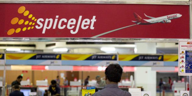 A traveler waits in front of a SpiceJet Ltd. ticket counter at Netaji Subhash Chandra Bose Domestic Airport in Kolkata, India, on Friday, April 8, 2011. Travel is surging in India, where the economy is estimated by the government to grow 9.25 percent in the current fiscal year, the fastest since the 12 months ended March 2008. Photographer: Brent Lewin/Bloomberg via Getty Images