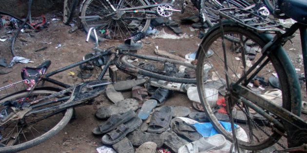 Malegaon, INDIA: Piles of discarded shoes and fallen bicycles litter a street outside a mosque in Malegaon,some 260kms north of Mumbai, 08 September 2006, after a series of bomb blasts. At least 37 people were killed and 50 others injured Friday in separate blasts in the western Indian town, officials said.The blasts occurred at Malegaon's Nurani mosque where devotees were offering Friday prayers. AFP PHOTO/Courtesy of SAKAL (Photo credit should read STRDEL/AFP/Getty Images)