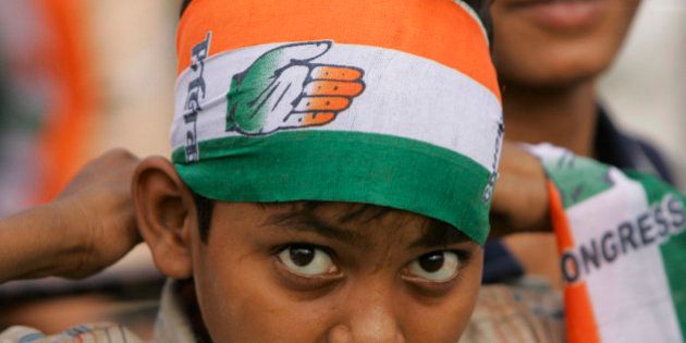A young supporter of India's ruling Congress party wears a scarf with party symbol, during an election rally in New Delhi, India, Sunday, May 3, 2009. (AP Photo/Gurinder Osan)