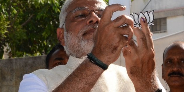 Indian Chief Minister for the western state of Gujarat and Bharatiya Janta Party (BJP) prime ministerial candidate Narendra Modi takes a 'selfie' after casting his vote at a polling station in Ahmedabad on April 30, 2014. Frontrunner for prime minister Narendra Modi declared an end to India's 'mother-son government' as he voted in his party's heartland in the latest stage of the country's mammoth elections. Voters queued early in 89 constituencies across nine states and territories in the latest leg of staggered voting in the world's biggest election which ends with results announced on May 16. AFP PHOTO / STR (Photo credit should read STRDEL/AFP/Getty Images)