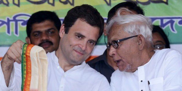 Congress vice-president Rahul Gandhi (L) and veteran Communist leader and former West Bengal chief minister Buddhadeb Bhattacharjee talk onstage during a joint rally between Congress and the Left Front political party in Kolkata on April 27, 2016. This is the first time rivals Congress and the Left Front have come together to campaign against the ruling Trinamool Congress in West Bengal's ongoing State assembly elections. / AFP / Dibyangshu SARKAR (Photo credit should read DIBYANGSHU SARKAR/AFP/Getty Images)