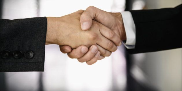 businessman and businesswoman shaking hands
