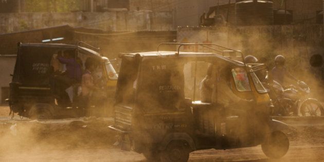 Auto-rickshaws kick up dust as they travel near the Delhi city boundary in Faridabad, Haryana, India, on Friday, April 8, 2106. The odd-even car rationing plan is scheduled to return on April 15 as Delhi Supreme Court is also set to hold a hearing regarding the large vehicle diesel ban. Both measures are aimed at curbing emissions in the world's most polluted city, according to a 2014 World Health Organization database. Photographer: Prashanth Vishwanathan/Bloomberg via Getty Images