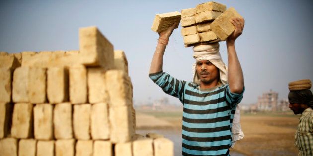 An Indian migrant worker stack bricks on his head at a brick factory in Lalitpur, Nepal January 11, 2016. REUTERS/Navesh Chitrakar