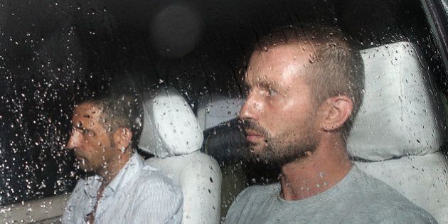 The two Italian marines accused of murdering two Indian fishermen leave after being released following a preliminary hearing on June 1, 2012 in a case that has caused a diplomatic row. Massimiliano Latorre and Salvatore Girone, who shot dead the fishermen off India's southwestern coast on February 15, appeared in the lower court in Kollam in the southern state of Kerala. The two marines deny murder, saying they mistook the fishermen for pirates. The court fixed June 18 for the next hearing and directed the state government to provide a list of interpreters 'for the benefit of the accused', the semi-official Press Trust of India news agency reported. AFP PHOTO (Photo credit should read -/AFP/GettyImages)