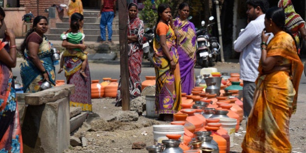 LATUR, INDIA - MARCH 23: People lined up with their pots to collect drinking water from government boring on March 23, 2016 in Latur, India. Of the total 1,133 farmers committed suicide in the region due to causes ranging from crop failure from lack of water to inability to meet loan payments, reported across the eight districts of Marathwada last year, 301were from Beed district. Summerâs just beginning but temperatures are already crossing 40 degrees Celsius in Beed, Latur and Osmanabad, the three districts worst-hit by the drought that is ravaging Marathwada. For the 65 lakh people who live there, itâs a struggle to get even their daily ration of 20 litres of water, hardly a bucketful. According to officials, of the 75 medium dams in Marathwada, 54 have completely dried up. The state had also declared drought in a few thousand villages in Vidarbha. The Maharashtra Govtâs Jalyukt Shivar scheme, which plans to make the state drought free by 2019 by widening streams and dam construction, may be underway but with barely 2 per cent water remaining in dams across Beed district, the scheme may find it difficult to prove its impact. (Photo by Arijit Sen/Hindustan Times via Getty Images)