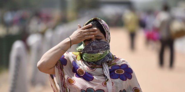 NEW DELHI, INDIA - APRIL 2: People cover themselves to protect against the hot summer day, as the heat wave conditions prevailed in Northern India with the maximum temperature settling at 38.9 degrees Celsius, five notches above the normal, on April 02, 2016 in New Delhi, India. The minimum temperature yesterday was recorded at 21.6 degrees Celsius while the maximum had settled at 37.3 degrees Celsius. (Photo by Sonu Mehta/Hindustan Times via Getty Images)