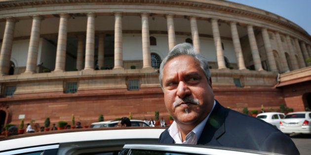 Indian business tycoon and owner of Kingfisher Airlines Vijay Mallya gets into his car outside Parliament in New Delhi, India, Wednesday, Feb. 27, 2013. According to local reports the Indian government has cancelled International flying rights and domestic slots of Kingfisher airlines. (AP Photo/Saurabh Das)