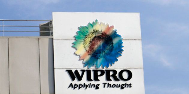 The Wipro Ltd. logo sits atop a building at the company's campus in Bangalore, India, on Tuesday, Jan. 28, 2014. Worldwide spending on information technology will grow 3.1 percent to $3.8 trillion this year, with IT services set to climb 4.5 percent, researcher Gartner Inc. forecast Jan. 6. Photographer: Vivek Prakash/Bloomberg via Getty Images