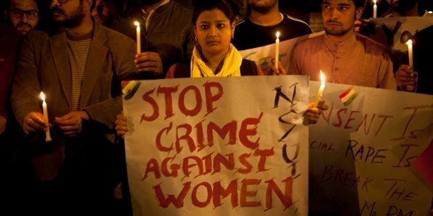 Indian youth hold candles during a protest against sexual violence in New Delhi, India, Monday, Feb. 9, 2015.Police were searching Monday for a man who raped a Japanese student sightseeing in northern India, while elsewhere they announced the arrest of eight men suspected of brutally raping and killing a Nepalese woman, as India authorities continue to struggle to address chronic sexual violence. (AP Photo/ Tsering Topgyal)