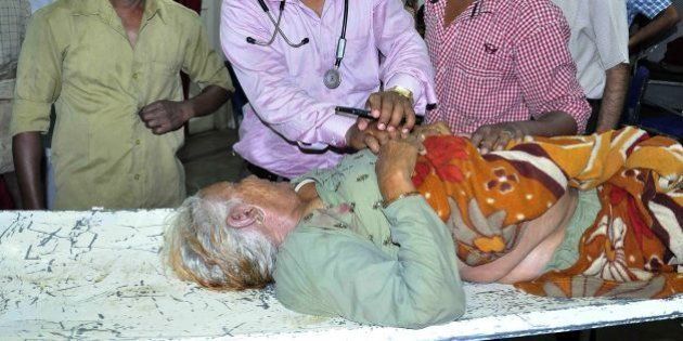 An Indian pilgrim injured after a tent collapse caused a stampede at a religious event is treated by medical staff at a hopsital in Ujjain on May 5, 2016.At least seven pilgrims were killed after a storm caused a tent to collapse onto devotees at the Kumbh Mela mass religious gathering in central India, triggering a small stampede, police said May 5. Forty others were injured when the makeshift tent caved in following strong winds at one of the sites of the Kumbh, a pilgrimage that draws millions over four weeks to participate in a sacred bathing ritual. / AFP / STR (Photo credit should read STR/AFP/Getty Images)