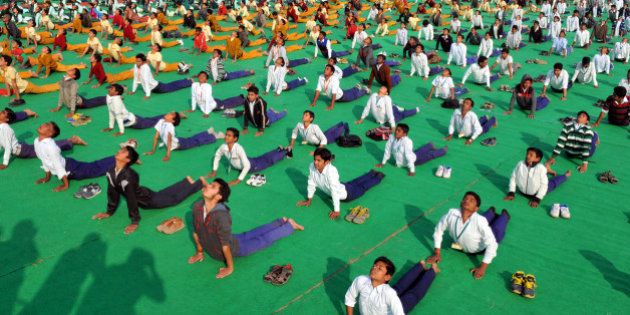 INDORE, INDIA - JANUARY 12: School students participate in Surya Namaskar function organized at Chiman Bagh Ground on the occasion of Swami Vivekanand Jayanti on January 12, 2016 in Indore, India. Surya Namaskar along with Pranayam will be held in all schools, colleges, panchayats and ashram shalas across the state. (Photo by Shankar Mourya/Hindustan Times via Getty Images)