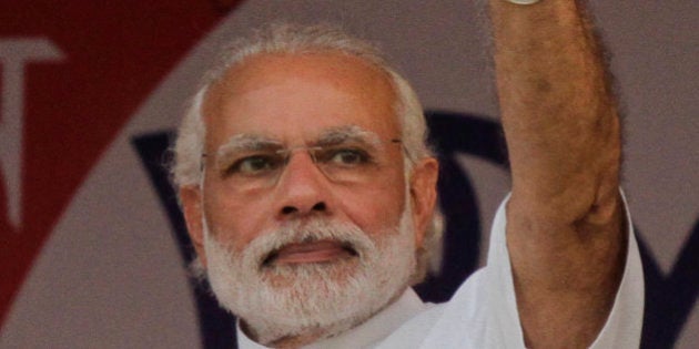 Indian Prime Minister Narendra Modi, waves as he arrives at an election rally of the ruling Bharatiya Janata Party (BJP), in Kolkata, India, Sunday, April 17, 2016. Modi is on a campaigning tour of the eastern Indian state of West Bengal for the state assembly elections. (AP Photo/ Bikas Das)