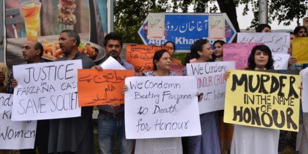 Pakistani human rights activists hold placards as they chant slogans during a protest in Islamabad on May 29, 2014 against the killing of pregnant woman Farzana Parveen was beaten to death with bricks by members of her own family for marrying a man of her own choice in Lahore. Pakistan's prime minister demanded 'immediate action' over the brutal murder of a pregnant woman who was bludgeoned to death with bricks outside a courthouse while police stood by. Farzana Parveen was attacked on May 27 outside the High Court building in the eastern city of Lahore by more than two dozen brick-wielding attackers, including her brother and father, for marrying against the wishes of her family. AFP PHOTO/Aamir QURESHI (Photo credit should read AAMIR QURESHI/AFP/Getty Images)