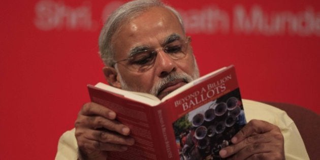 MUMBAI, INDIA - JUNE 27: Gujarat Chief Minister Narendra Modi reading the book Beyond A Billion Ballots by Vinay Sahasrabuddhe at its launch at Bombay Stock on June 27, 2013 in Mumbai, India. It was his first visit to the city after he was made the head of BJP's Lok Sabha campaign committee over a fortnight ago. (Photo by Vijaynanand Gupta/Hindustan Times via Getty Images)