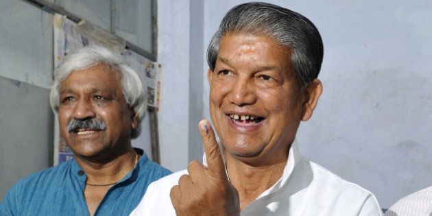 DEHRADUN, INDIA - MAY 7: Uttrakhand Chief Minister Harish Rawat showing ink stained finger after casting his vote at polling centre during 8th phase of Lok Sabha election on May 7, 2014 in Dehradun, India. 1,737 candidates are contesting on 64 seats in seven states in eighth phase of Lok Sabha election. (Photo by Rishi Ballabh/Hindustan Times via Getty Images)