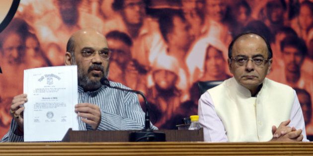 NEW DELHI, INDIA MAY 09: Finance Minister Arun Jaitley and BJP President Amit Shah during a press conference to show the degrees of Prime Minister Narendra Modi at BJP headquarters in New Delhi.(Photo by Pankaj Nangia/India Today Group/Getty Images)