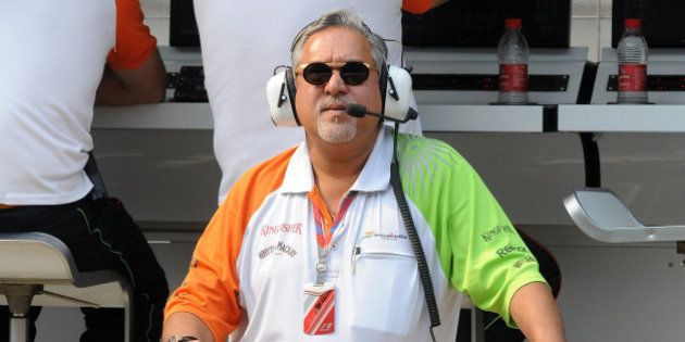 Force India-Mercedes Team Principal Vijay Mallya watches the big screen during the first practice session of Formula One's Indian Grand Prix at the Buddh International circuit in Greater Noida on October 28, 2011. India will host its first Formula One Grand Prix on October 30. AFP PHOTO/ Prakash SINGH (Photo credit should read PRAKASH SINGH/AFP/Getty Images)