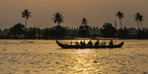 Tourists travel in a boat along the backwaters at sunset in Alappuzha, Kerala, India, on Saturday, May 30, 2015. Prime Minister Narendra Modi is counting on a revival in credit to accelerate growth in Asia's third-largest economy after the RBI cut its benchmark interest rate three times this year. Photographer: Dhiraj Singh/Bloomberg via Getty Images