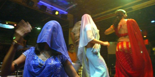 Indian bar girls perform at a dance bar in Bombay May 5, 2005. The government of the western Indian state of Maharashtra on Wednesday endorsed the decree seeking to ban dance bars in the state. There are more than 600 dance bars in Bombay itself and the closure of cabarets is likely to render jobless more than 150,000 people across the state including dancers, waiters, bouncers and security guards. Most bars in the state employ girls, who dress in colourful costumes and dance to Bollywood songs, as customers shower them with currency bills. According to bar girl's union, the majority of the 75,000 girls working in bars will be forced into the