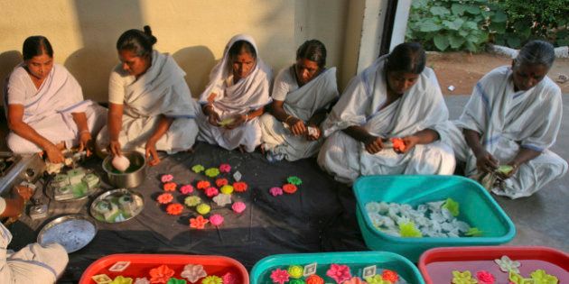 Women inmates prepare scented floating wax candles inside Chanchalguda Women Prison for the Hindu festival of Diwali in the Southern Indian city of Hyderabad October 24, 2011. Jail authorities have initiated many programs like baking, tailoring and candle making for inmates to upgrade their work skills and prepare them for the responsibilities of life after prison, the director general of prisons CN Gopinath Reddy said. The prisoners can earn about 50 Indian Rupees ($1) for eight hours of work, he added. REUTERS/Krishnendu Halder (INDIA - Tags: RELIGION SOCIETY BUSINESS)