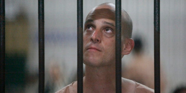 Australian writer Harry Nicolaides waits inside a detention cell of the Bangkok's Criminal Court January 19, 2009. Nicolaides pleaded guilty to defaming Thailand's crown prince on Monday and faces up to 15 years in jail when he is sentenced later in the day. REUTERS/Sukree Sukplang (THAILAND)