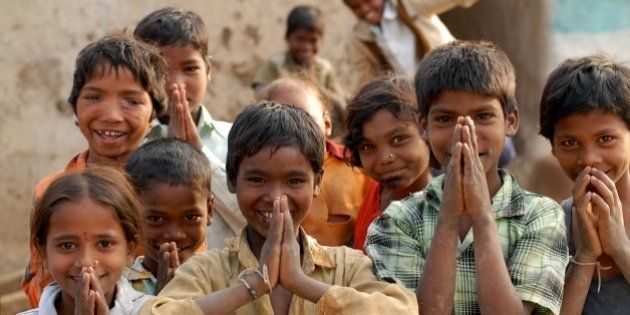 India: Children in a village near Nagpur, Maharashtra, doing 'Namaste' which is a form of welcome or greeting. Jan 29, 2007. (Photo by: Majority World/UIG via Getty Images)