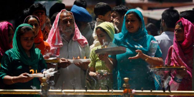 Kashmiri Hindus, or Pandits, pray during an annual festival at a shrine in Khirbhawani, 30 km (19 miles) east of Srinagar June 11, 2008. Every year thousands of displaced Kashmiri Hindus, known as Pandits in Kashmir, gather at the holy shrine in the restive Indian state of Jammu and Kashmir to pray for peace and their early return home. More than 200,000 Hindus fled their homes when an armed rebellion broke out in the Himalayan region at the end of 1989. REUTERS/Fayaz Kabli (INDIAN ADMINISTERED KASHMIR)