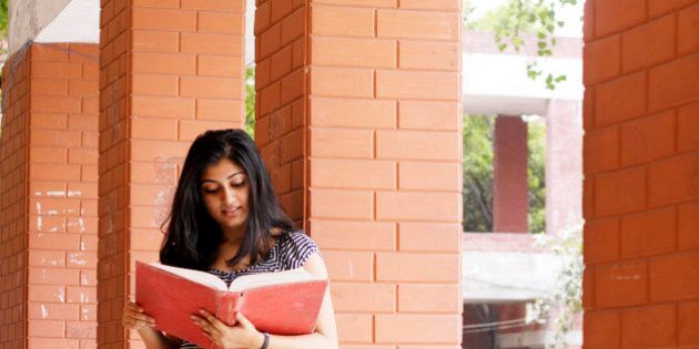 An Indian Student reading a book