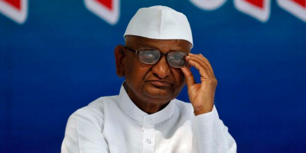 Veteran Indian social activist Anna Hazare adjusts his glasses as he attends a sit-in protest in New Delhi February 23, 2015. A bid by Indian Prime Minister Narendra Modi to make it easier for businesses to buy farm land for infrastructure and industry has sparked a backlash that could stymie his efforts to get reforms through a parliament session that began on Monday. While the change is aimed at unlocking hundreds of billions of dollars worth of projects, which have been stuck for want of land, opposition parties and rights activists say it discriminates against farmers. Hazare launched a two-day sit-in on Monday with his followers against the decree in New Delhi. REUTERS/Ahmad Masood (INDIA - Tags: POLITICS BUSINESS CIVIL UNREST AGRICULTURE)