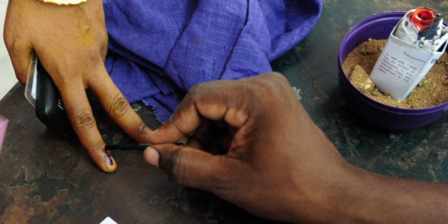 An Indian electoral official marks the finger of a voter with ink at a polling station in Chennai on May 16, 2016, during voting in state assembly elections in the southern Indian state of Tamil Nadu.Voting in the southern Indian states of Tamil, Nadu, Kerala and Pondicherry for state assembly elections is taking place on May 16. / AFP / ARUN SANKAR (Photo credit should read ARUN SANKAR/AFP/Getty Images)