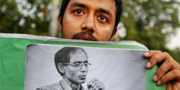 A Bangladeshi student holds a portrait of a University Professor A.F.M. Rezaul Karim Siddique during a protest against the killing in Dhaka, Bangladesh, Friday, April 29, 2016. Professor Siddique was hacked to death on his way to work at the state-run university in the Bangladeshi city of Rajshahi on April 23, 2016, where he taught English. The Islamic State group claims responsibility, but the government dismissed the claim and instead blames local religious radicals. (AP Photo)