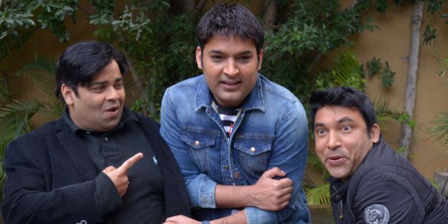 Indian stand-up comedians and Bollywood actors Kapil Sharma (C) Chandan Prabhakar (R) Kiku Sharda(L)share a light moment during a promotional event for the forthcoming comedy show 'The Kapil Sharma Show ' in Amritsar on March 5, 2016. / AFP / NARINDER NANU (Photo credit should read NARINDER NANU/AFP/Getty Images)
