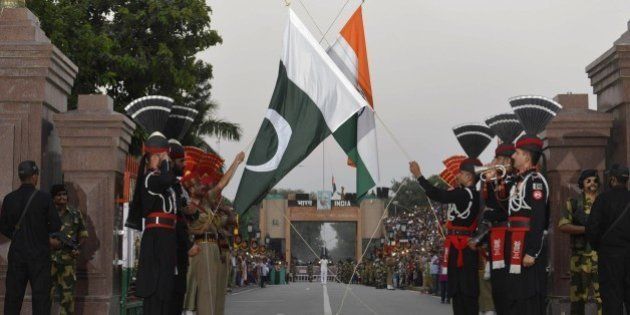 Pakistani Rangers (in black) and Indian Border Security Force (BSF) personnel perform the flag off ceremony at the Pakistan-India Wagah Border on September 12, 2015. Pakistan and India have fought two of their three wars over the Himalayan region since both gained independence in 1947, and it remains a major source of tension. AFP PHOTO / ARIF ALI (Photo credit should read Arif Ali/AFP/Getty Images)