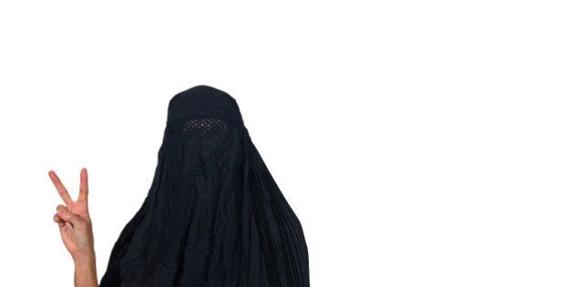 Woman in a burka making a peace sign