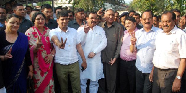 DEHRADUN, INDIA - MARCH 31: (L-R) Congress rebel Shaila Rani Rawat, Amrita Rawat, Pradeep Batra, Harak Singh Rawat, Vijay Bahuguna, Umesh Sharma Kau, Subodh Uniyal and Shailendra Mohan Singhal showing victory sign after a press conference on March 31, 2016 in Dehradun, India. Complicating the legalities around a floor test in the Uttarakhand Assembly that former Chief Minister Harish Rawat had to take on Thursday, a Division Bench of the High Court in Nainital, decided to keep the order on the floor test in abeyance till April 6. (Photo by Vinay Santosh Kumar/Hindustan Times via Getty Images)