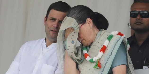 Indiaâs Congress party president Sonia Gandhi wipes her sweat as partyâs vice-president Rahul Gandhi (L) watches during a farmers rally at Ramlila ground in New Delhi, India, September 20, 2015. REUTERS/Adnan Abidi