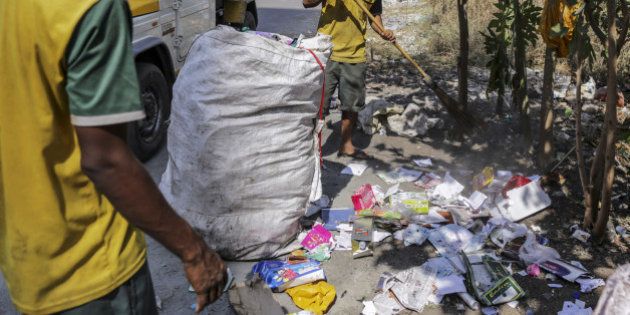 A clean up team for the Flying Debris Squad of the Navi Mumbai Municipal Corporation (NMMC), collect garbage dumped on the side of a road in Navi Mumbai, Maharashtra, India, on Tuesday, Feb. 2, 2016. Some of India's major municipalities are putting in place anti-garbage programs using smartphone technology to try to vanquish India's Sisyphean waste problems and ubiquitous trouble with litter. Photographer: Dhiraj Singh/Bloomberg via Getty Images