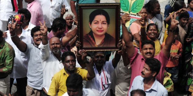 Members of the All India Anna Dravida Munnetra Kazhagam(AIADMK) party carry placards with the image of AIADMK leader Jayalalithaa Jayaram as they celebrate in front of her residence in Chennai on May 19, 2016.The makeup of India's next government could lie in the hands of a trio of women who command a massive following in their regional heartlands, including a populist former movie star known as 'Mother' to supporters. / AFP / ARUN SANKAR (Photo credit should read ARUN SANKAR/AFP/Getty Images)