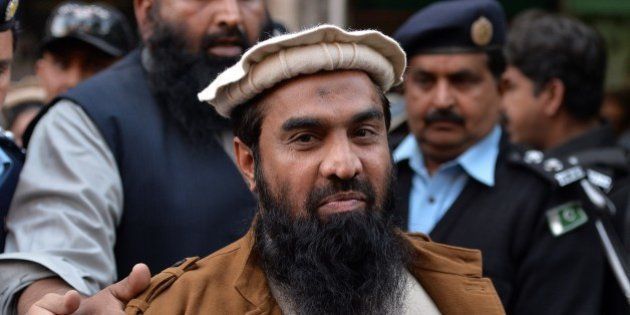 Pakistani security personnel escort Zaki-ur-Rehman Lakhvi (C), alleged mastermind of the 2008 Mumbai attacks, leaves the court after a hearing in Islamabad on January 1, 2015. Pakistan on January 1, approached the country's supreme court to stop the release of alleged mastermind of the 2008 Mumbai attacks whose detention order was this week suspended by a high court, a government prosecutor said. AFP PHOTO/ Aamir QURESHI (Photo credit should read AAMIR QURESHI/AFP/Getty Images)