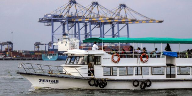 A ferry travels past the Kochi International Container Transhipment Terminal (ICTT), operated by DP World Ltd., in Cochin, India, on Friday, May 29, 2015. India is gearing up for a deficient monsoon for a second year, signaling record food imports, efforts to cushion farmers and contingencies for lower hydroelectricity. Photographer: Dhiraj Singh/Bloomberg via Getty Images