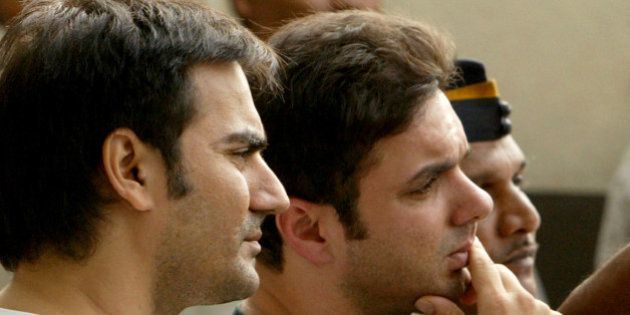 Brothers of Bollywood star Salman Khan and actors Arbaaz Khan, left, and Sohail Khan, center, look on as Salman Khan's lawyer Dipesh Mehta, unseen, speaks to journalists at Salman's residence in Mumbai, India, Friday, Aug. 24, 2007. An Indian court upheld Khan's conviction for poaching a rare buck in a wildlife preserve, rejecting the actor's appeal and ordering him to start serving his five-year prison sentence, lawyers said. (AP Photo/Gautam Singh)