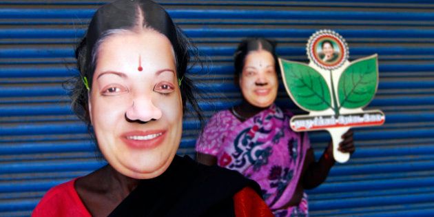 Supporters of J. Jayalalithaa, chief minister of India's Tamil Nadu state and chief of Anna Dravida Munetra Khazhgam (AIADMK), wear masks and hold her party's symbol during an election campaign ahead of the general elections in the southern Indian city of Chennai March 21, 2014. The politics of forming India's next government could come down to how many seats a 1960s matinee siren can wrest from a rival named Stalin in Tamil Nadu. Picture taken March 21, 2014. REUTERS/Babu (INDIA - Tags: POLITICS ELECTIONS)